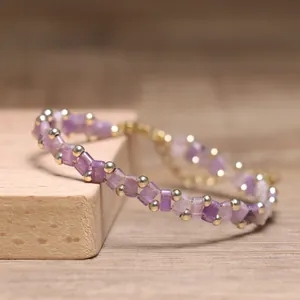 Close-up detail of a purple Tila bead handmade bracelet with gold accent spacers