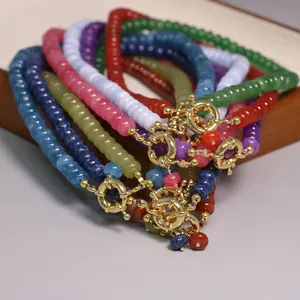 Detalle de pulseras de cuentas de ábaco de 5x8mm de colores con cierres marineros dorados