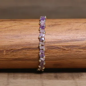 Detailed close-up of a handmade purple Tila bead bracelet with metallic spacers