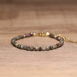 Close-up of bohemian natural stone faceted beaded bracelet on a wooden surface