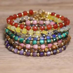 Close-up of assorted natural stone faceted beaded bracelets with gold spacers
