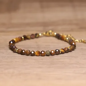 Detailed view of faceted natural tiger eye stone beads on a handmade bracelet