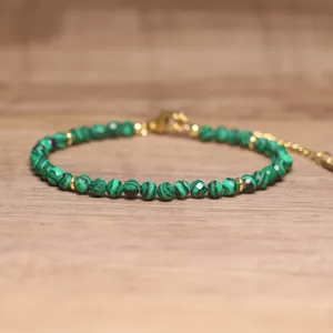 Close-up of faceted green malachite beads on an adjustable handmade bohemian bracelet