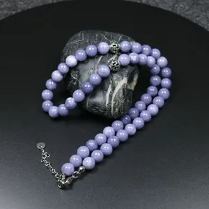 Primer plano de cuentas de oración de piedra natural violeta con cierre de langosta.