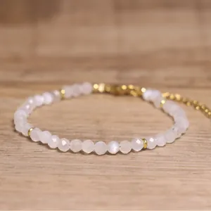 Close-up of faceted white natural stone beads on a bohemian style adjustable bracelet.