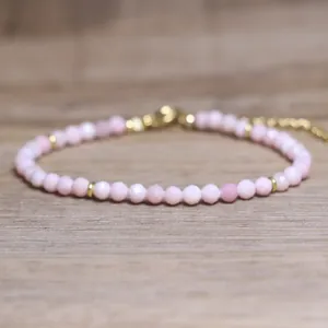 Macro detail of natural pink faceted stone beads on a delicate adjustable bracelet