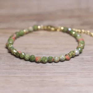 Macro view of faceted natural stone beads on a Bohemian style adjustable bracelet.