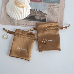 Elegant brown satin drawstring gift pouches for jewelry storage with silky fabric finish