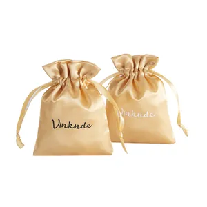 Two champagne gold satin drawstring bags for jewelry storage and gift packaging