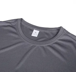 Close-up of gray men's waffle knit t-shirt with 100% polyester label and neckline detail.