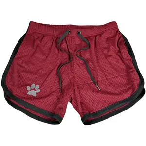 Detailed view of burgundy mesh athletic shorts featuring black trim and a grey paw print