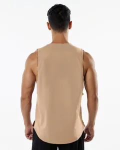 Close-up of the back design of a tan sports tank top with arched hem and side slit