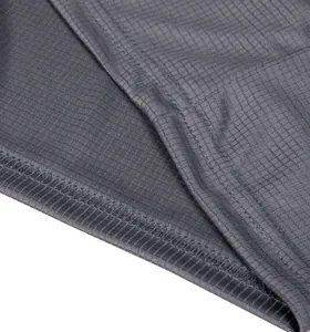 Detailed macro view showing the breathable checkered texture of grey sports fabric