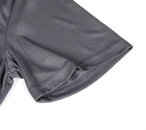 Detailed macro view of the small grid texture on a grey quick-dry sport shirt sleeve