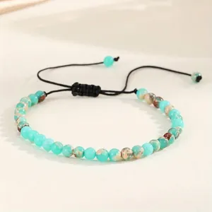 Detailed view of 4mm natural green agate beads on a black adjustable braided cord