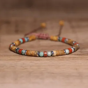 Close-up of 2x4mm natural stone beads on a handmade adjustable braided bracelet.