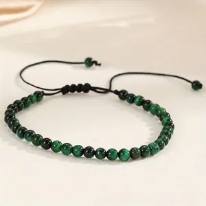 Detailed macro view of 4mm green agate beaded bracelet with adjustable black cord