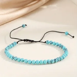 Detailed view of 4mm turquoise bead bracelet with adjustable black braided cord design