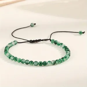 Close-up detail of 4mm natural green agate beads on an adjustable woven bracelet cord
