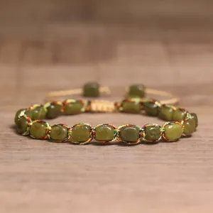 Detailed close-up of a 4mm natural stone braided bracelet with colorful silk thread