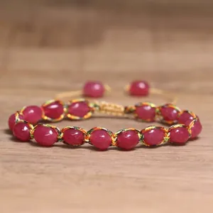 Detail view of a 4mm natural tourmaline stone woven bracelet with colorful thread