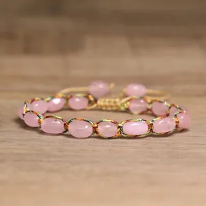 Detailed shot of 4mm pink natural stone beads wrapped in colorful woven adjustable cord
