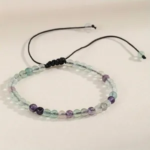 Detailed macro shot of a 4mm natural agate bead bracelet with a black adjustable cord