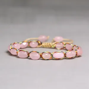 Handmade braided bracelet with natural pink stones and adjustable colorful thread