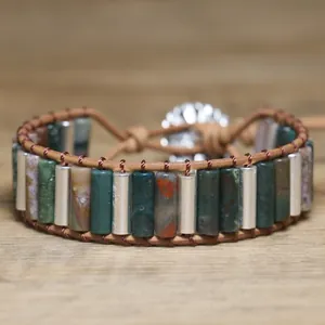 Detailed view of handmade woven bracelet with green and marbled stone tubes