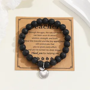 Natural lava stone bead bracelet with silver apple charm on teacher thank you gift card