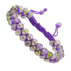 Close-up of double-row handmade braided natural stone bracelet with purple cord.