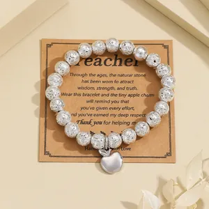 Silver-tone textured bead bracelet with an apple charm on a Teacher gift card detail