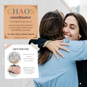 Two women hugging while wearing a natural stone bead bracelet with included gift cards.