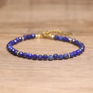 Detail view of faceted lapis lazuli beads and gold spacers on this bohemian bracelet.