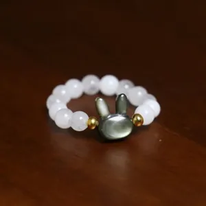 Close-up of shell pearl beaded ring featuring a cute grey bunny-shaped centerpiece