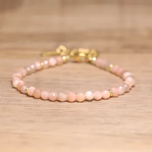Close-up of faceted peach natural stone beads on a handmade bohemian bracelet