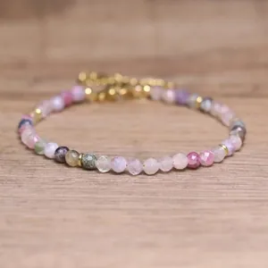 Detailed macro view of faceted multi-color natural stone beads on boho bracelet