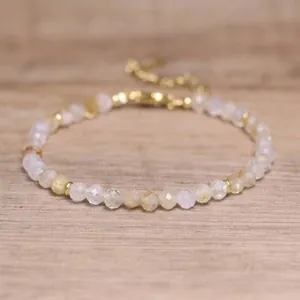 Detailed close-up of faceted natural stone beads on a bohemian style gold bracelet