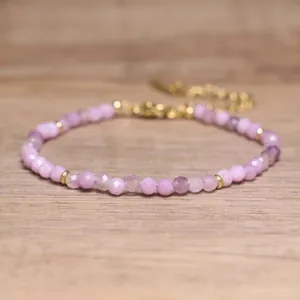 Macro view of faceted light purple natural stone beads on a handmade bohemian bracelet