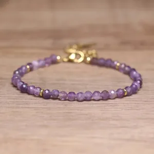Detailed view of faceted purple natural stone beads on a handmade adjustable bracelet.