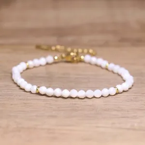 Detail view of handmade faceted white stone beaded bracelet with golden adjustable chain