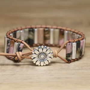 Detailed macro view of a vintage sunflower clasp on a handmade natural stone wrap bracelet