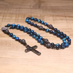 Close-up detail of natural blue tiger eye beads and lava stone rosary with black cross