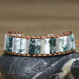 Detailed macro view of hand-woven wrap bracelet with cylindrical green stone beads