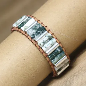 Detail of handmade moss agate tube bead woven wrap bracelet in natural green tones