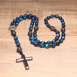 Detailed view of blue tiger eye and lava stone rosary necklace with cross pendant