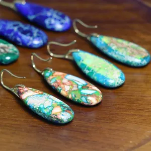 Primer plano de pendientes de gota de jaspe imperial natural con ganchos dorados