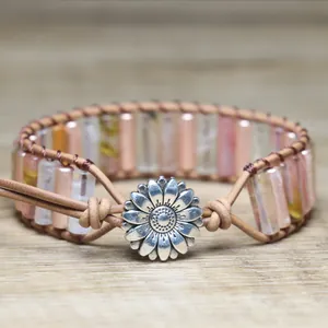 Close-up of retro handmade woven bracelet with pink beads and silver flower button.