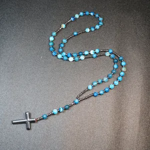 Detailed close-up showing blue striped agate beads and hematite cross pendant necklace