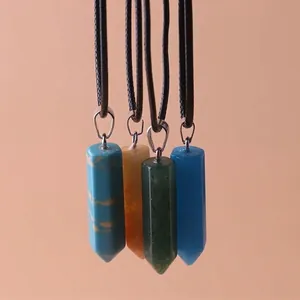 Detailed close-up of four hexagonal quartz crystal column pendant necklaces with black cords